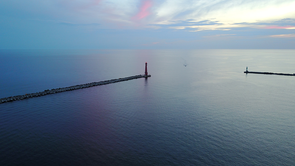 Boat approaching the Muskegon channel from Lake Michigan on a calm day