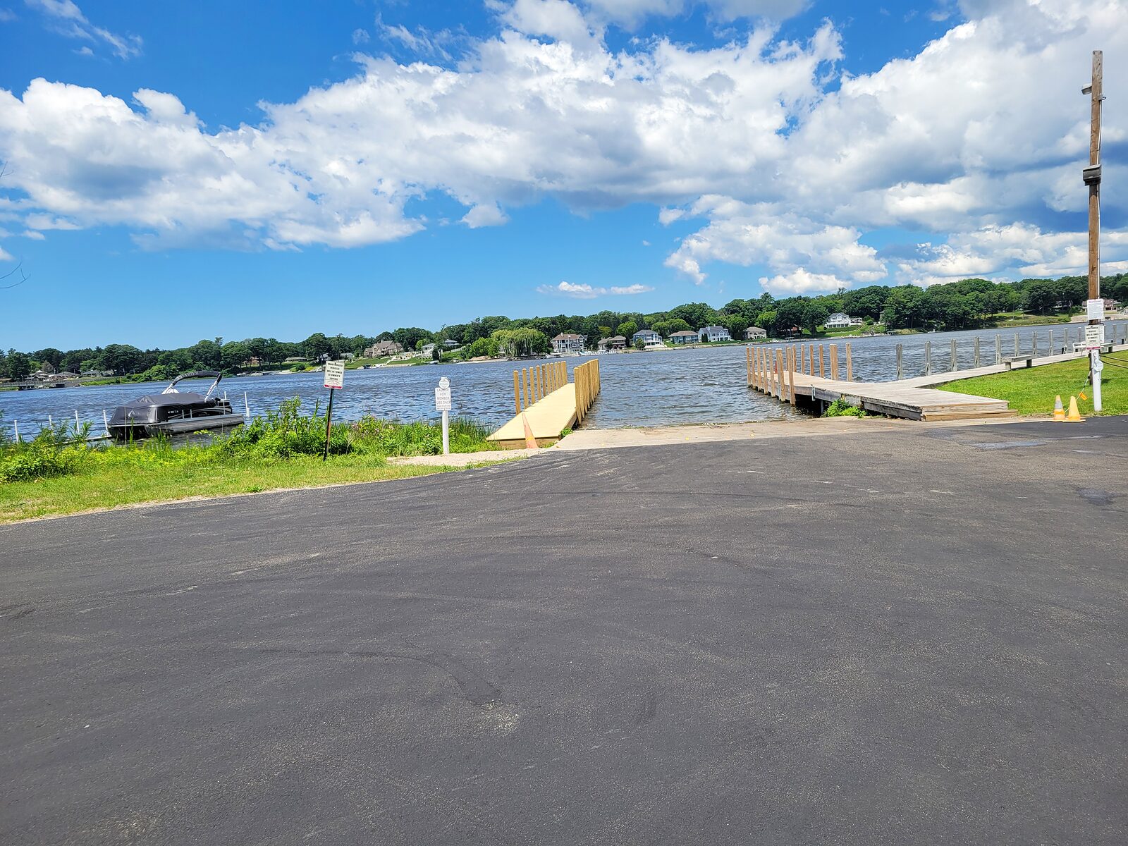 A paved boat launch ramp and floating dock on the south shore of Mona Lake