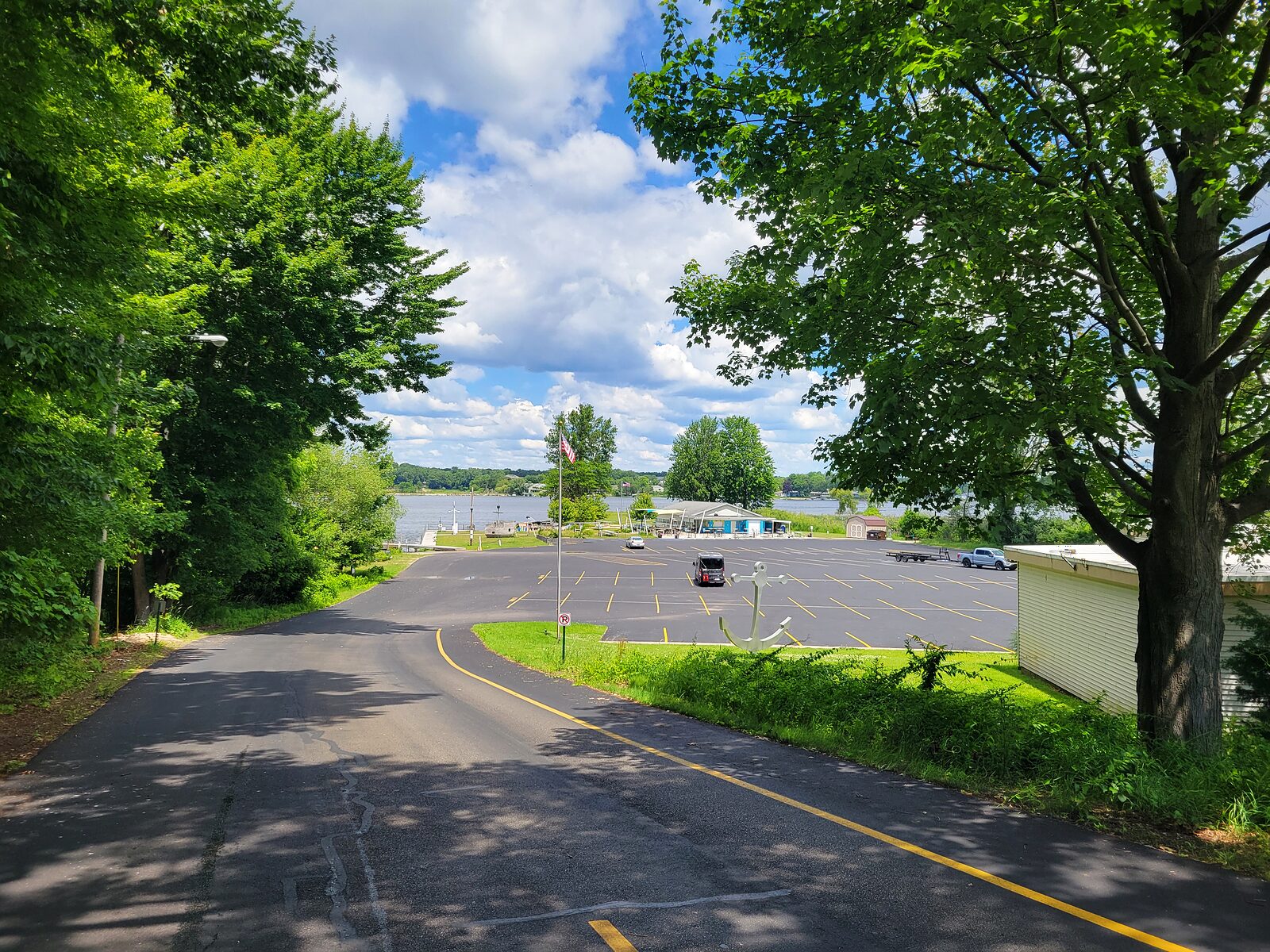 View over Mona Lake from the wooded bluff above the south-shore launch in Norton Shores