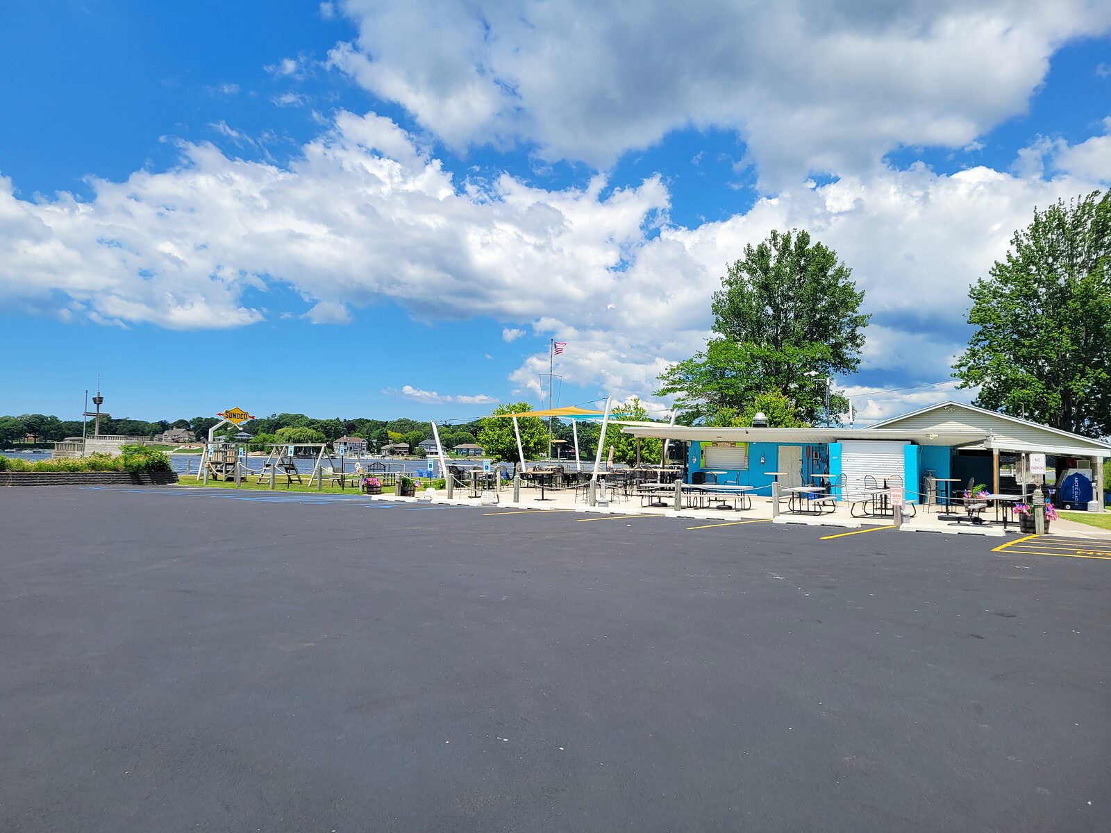 The blue lakeside clubhouse and patio at the private Mona Lake Boating Club