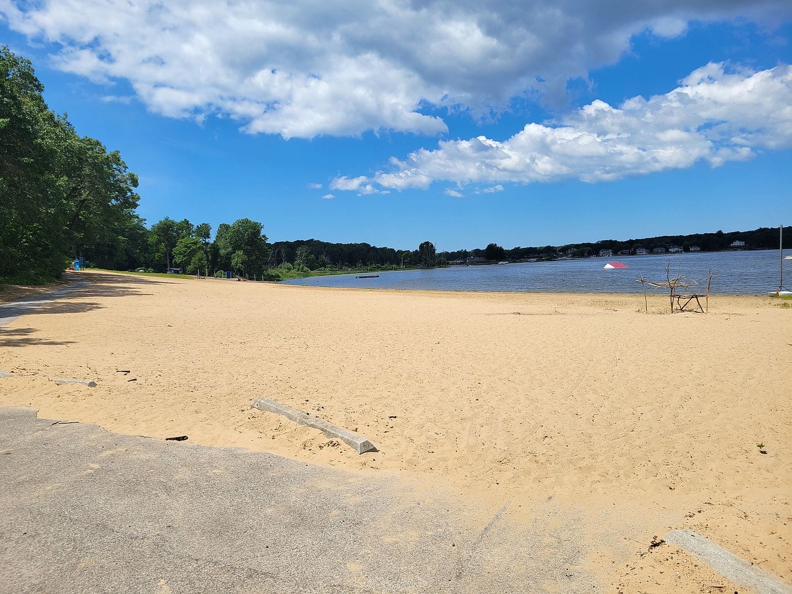 The sandy swimming beach at Ross Park looking out over Mona Lake in Norton Shores