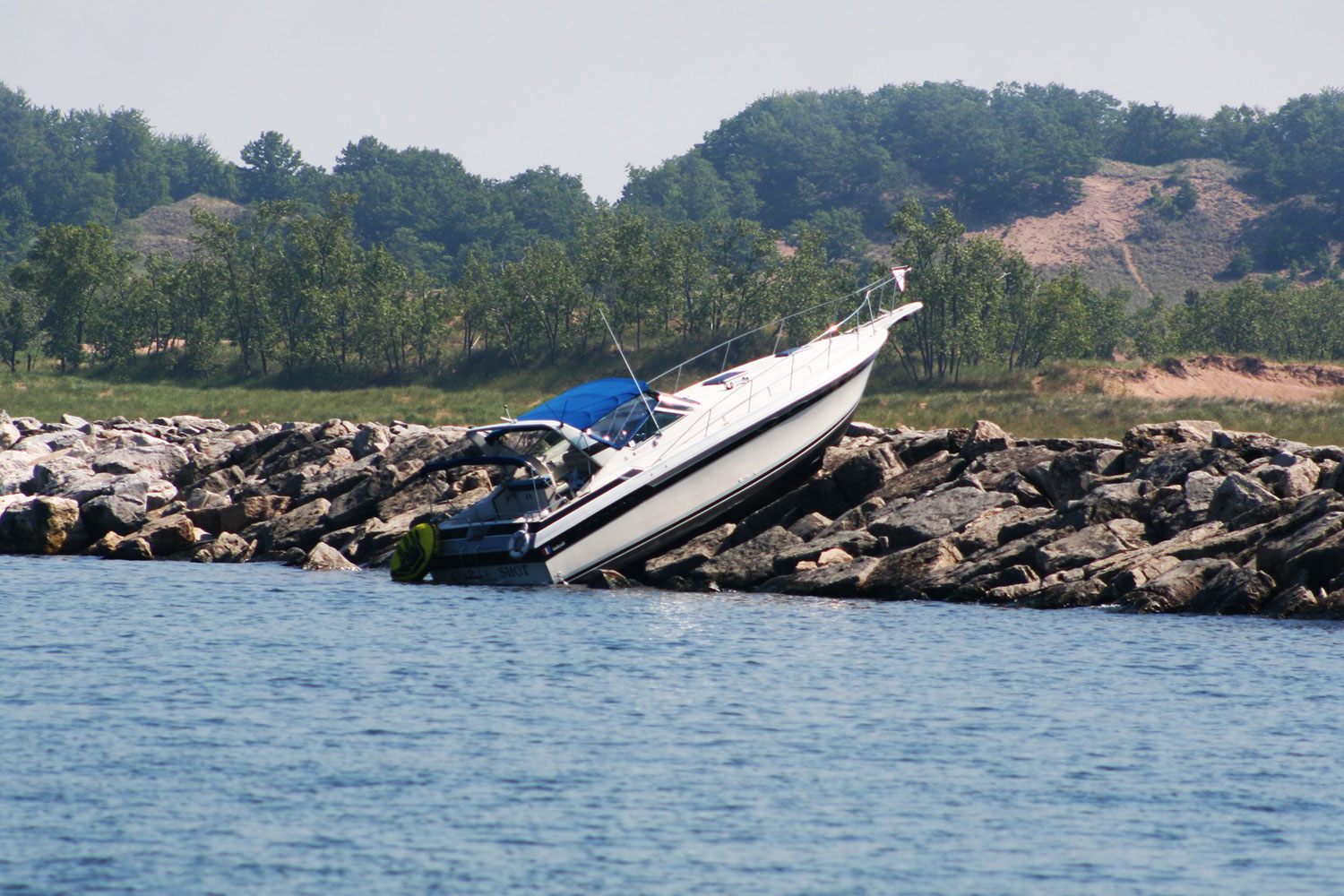 Boat run aground on the rock breakwall separating the Muskegon channel from Lake Michigan after heavy fog