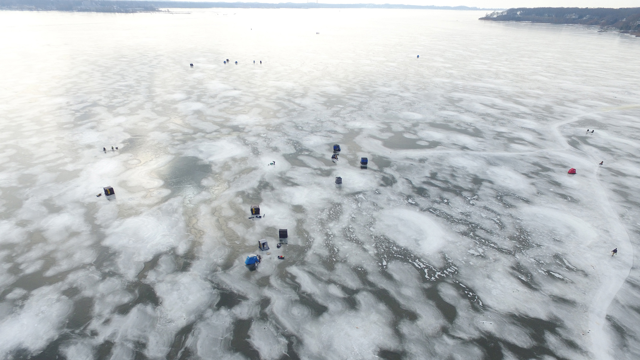 Ice fishing on Muskegon Lake in winter viewed from North Muskegon Michigan