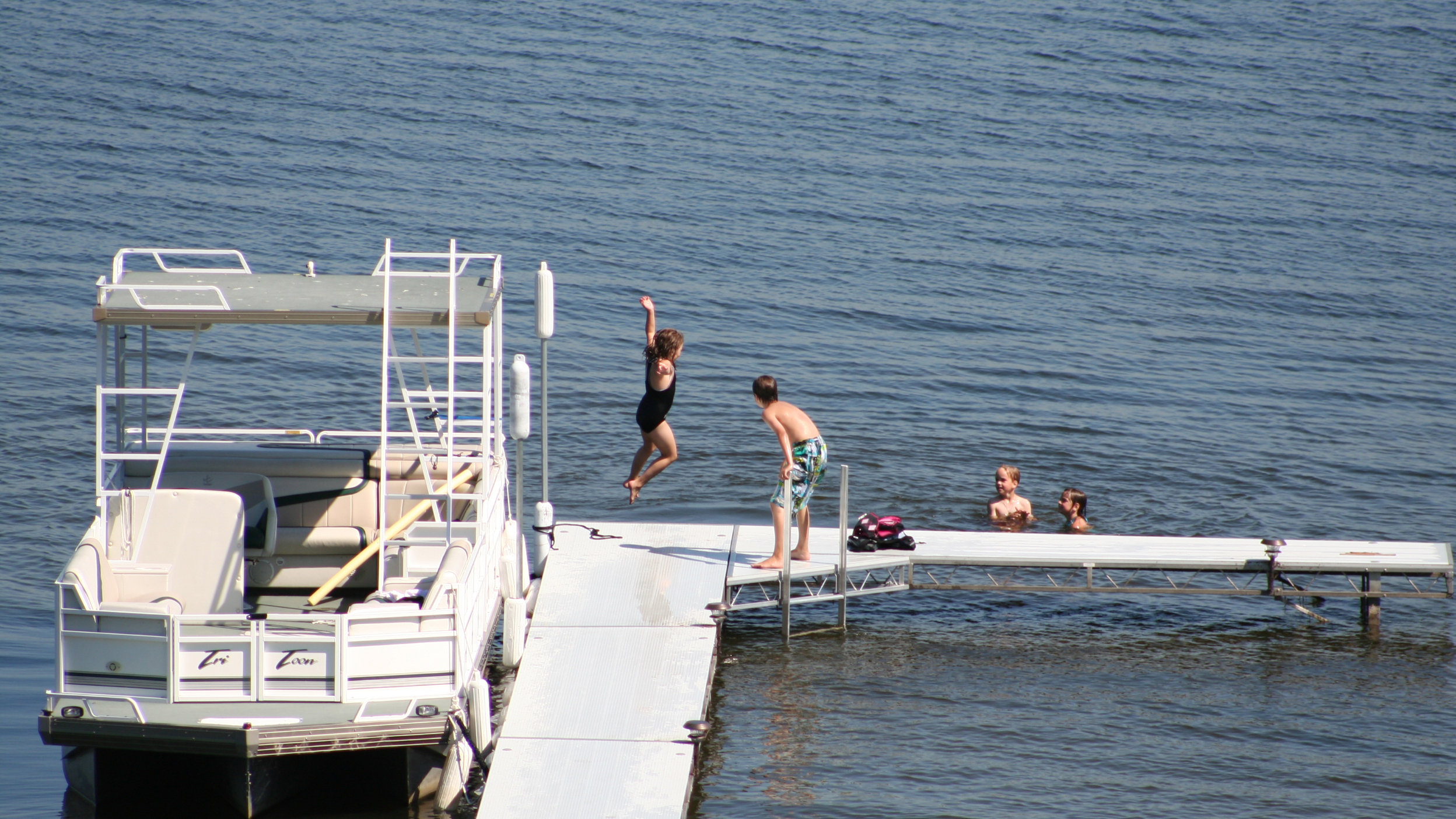 Sandy beach on the North Muskegon side of Muskegon Lake with dock and waterfront living