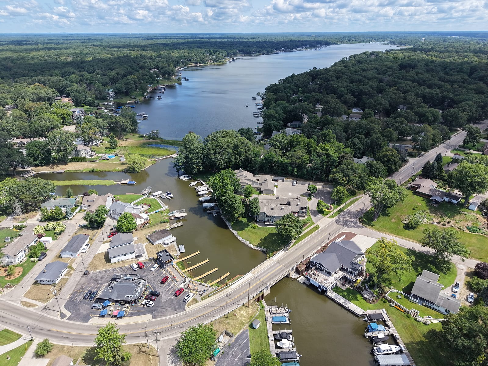 Channel Pointe from the air: two condo buildings on the east bank of the Bear Lake Channel above the Ruddiman Drive bridge, the Bear Lake Tavern across the channel, and Bear Lake beyond
