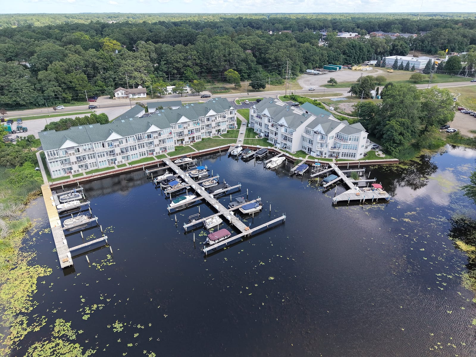 North Pier condos from the air: the enclosed boat slip basin on the still water of the Muskegon River delta