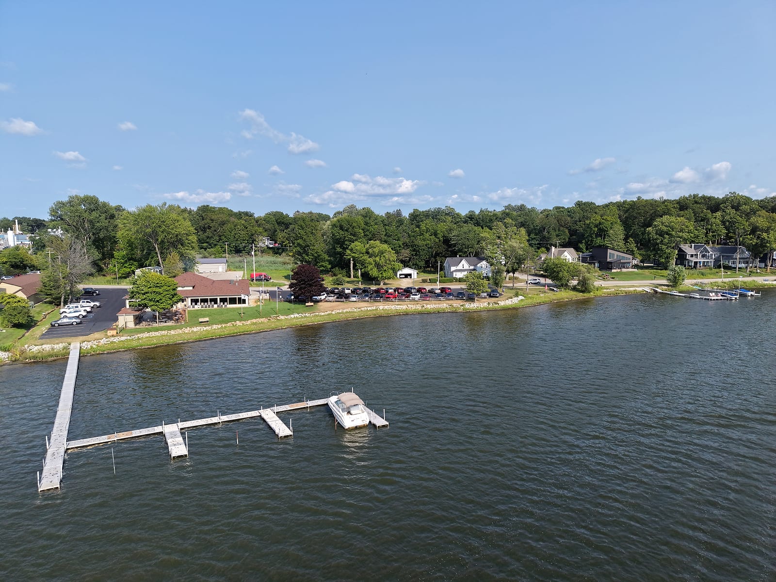 Aerial view of the Eagles club on White Lake in Whitehall with its dock and one boat tied up in front of the clubhouse