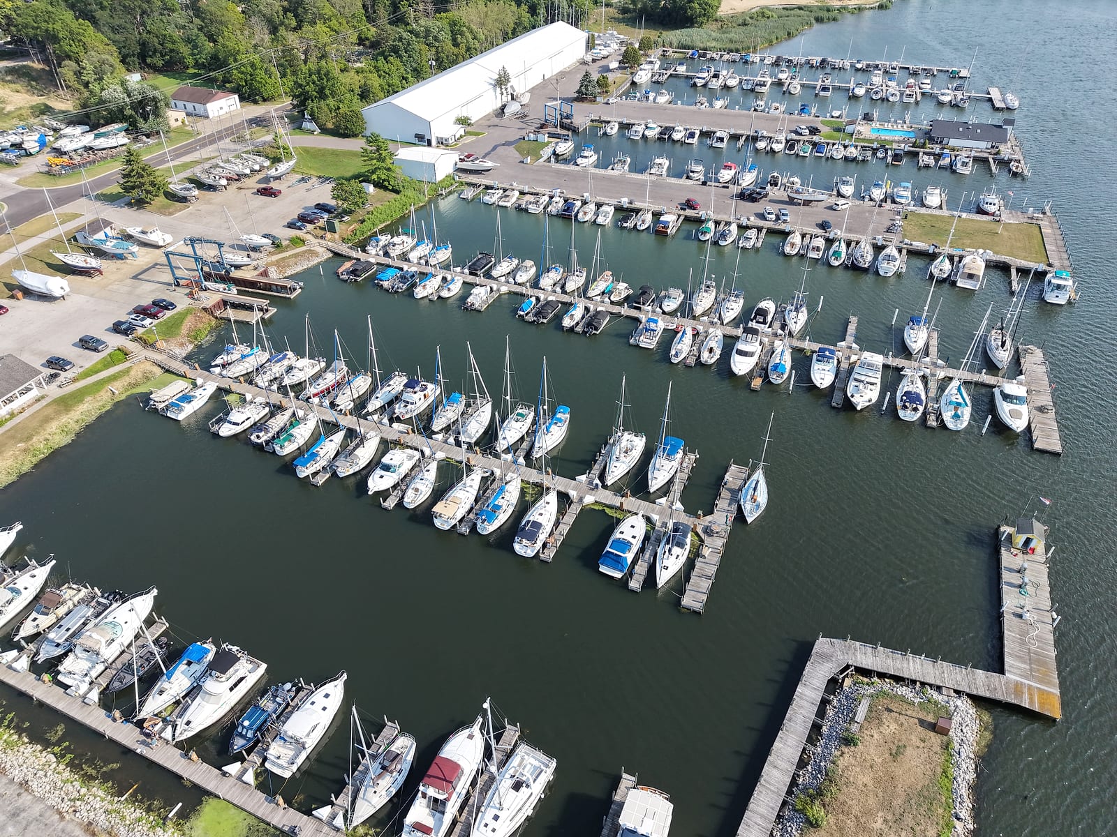 Aerial view of Crosswinds Marine Service, a large private marina on upper White Lake, with hundreds of boat slips, a storage building, and a boatyard